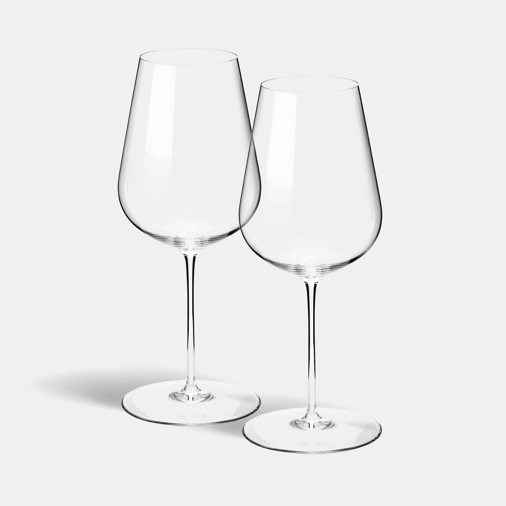A pair of mouth-blown universal wine glasses with fine tapered bowls.